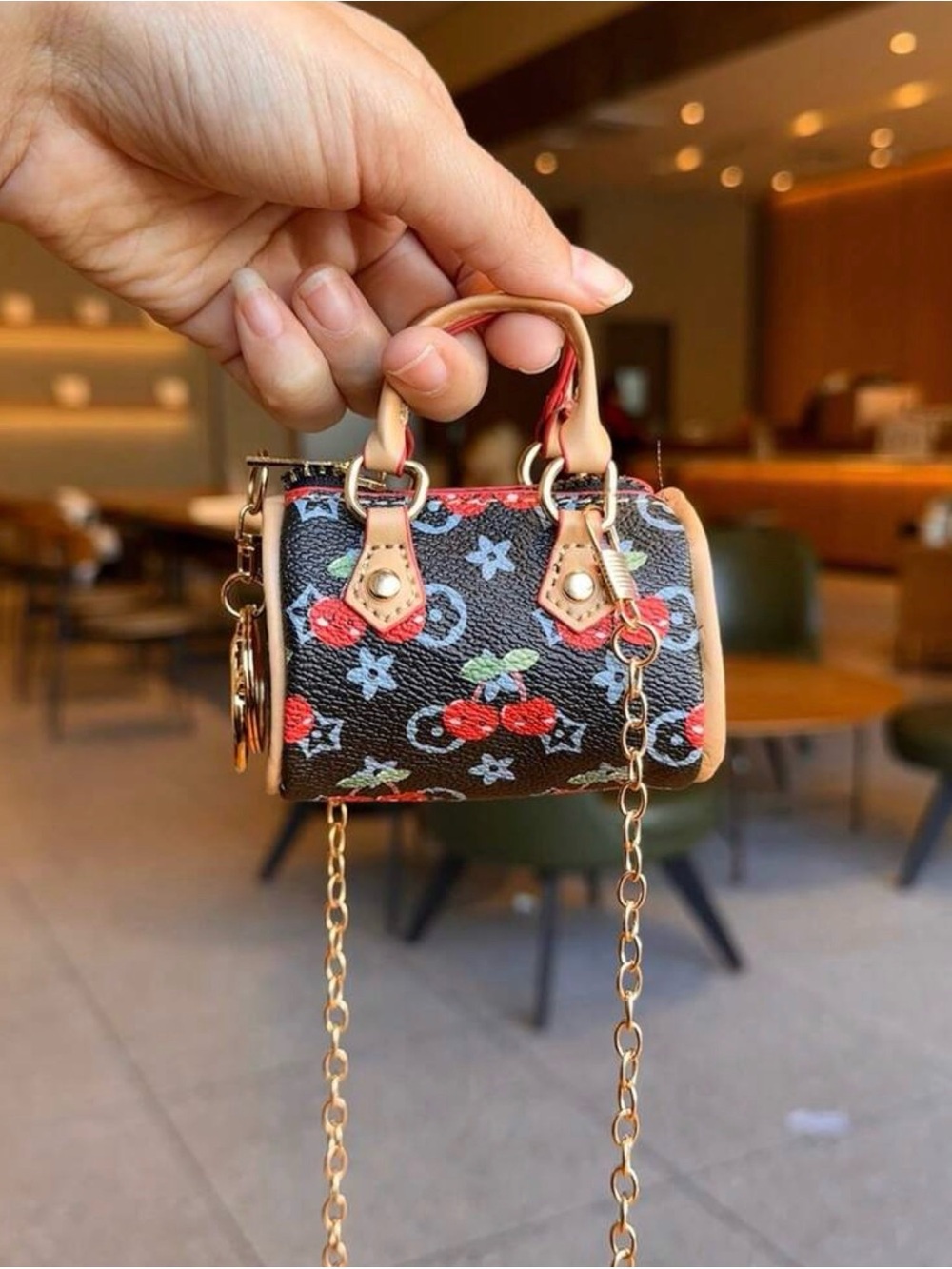 Mini Cherry-Print Coin Bag/Crossbody in
Black with Gold Hardware.